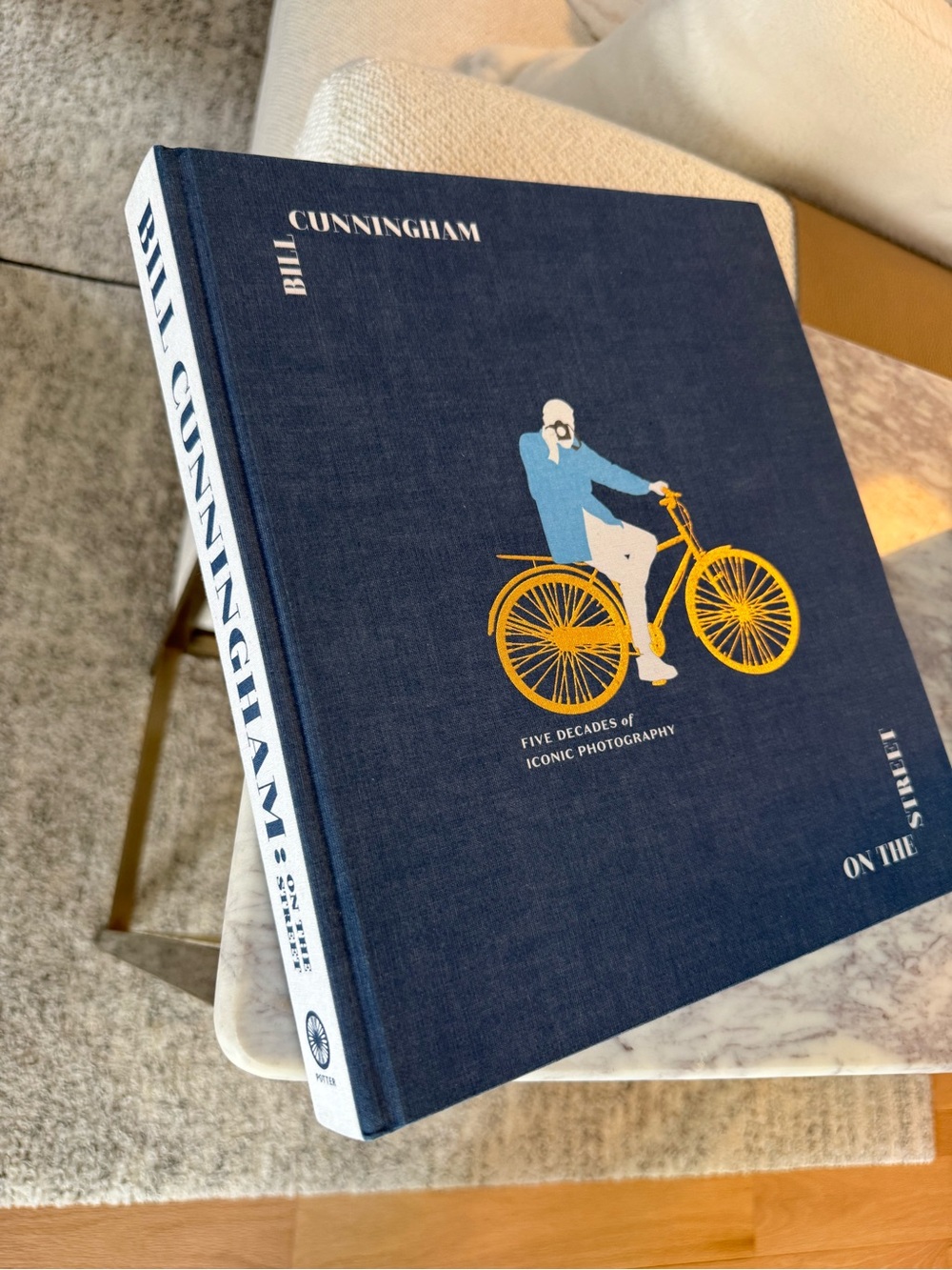 New Bill Cunningham Hardcover Book - Navy Blue with Yellow Bicycle Illustration